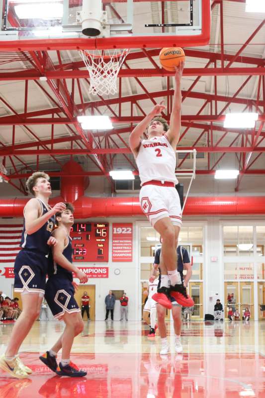 a basketball player dunking a basketball in a gym