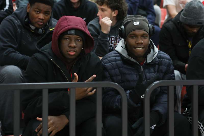 a group of men sitting in a crowd
