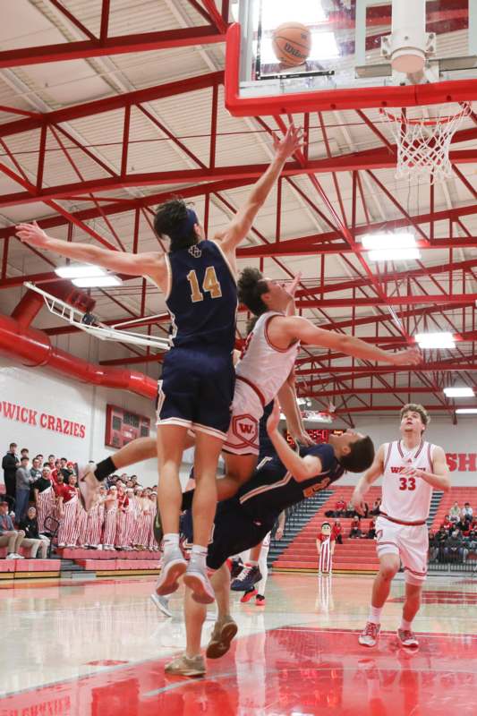 a group of people playing basketball