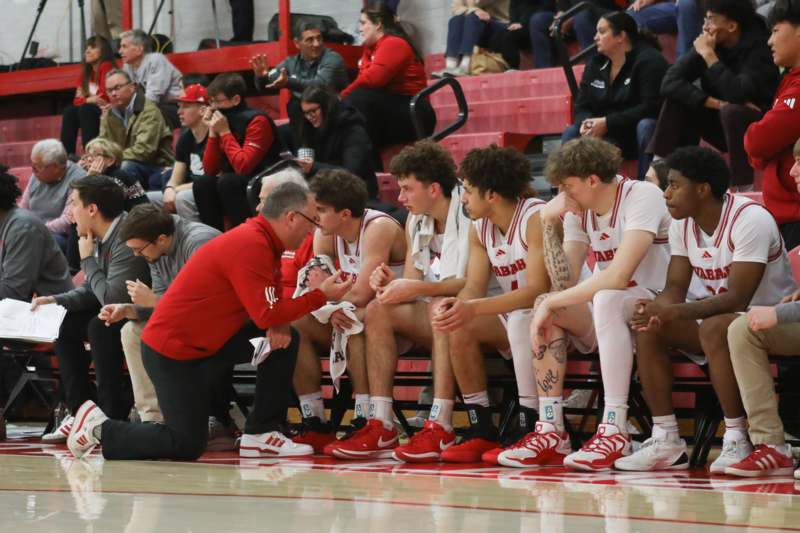 a coach talking to a basketball team