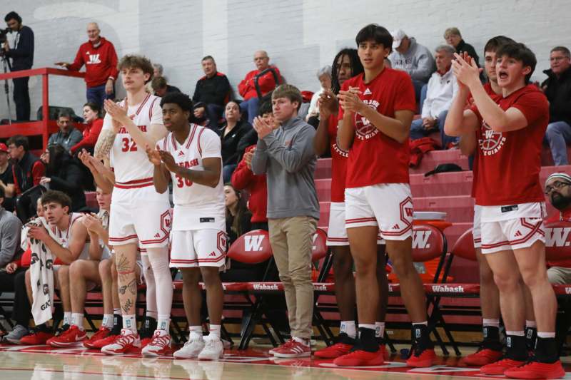 a group of people standing in a row clapping