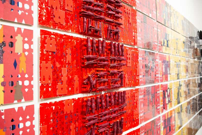 a wall of red art pieces