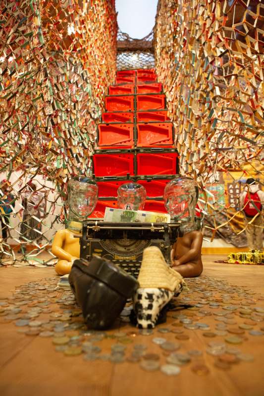 a room with a typewriter and many stacks of coins