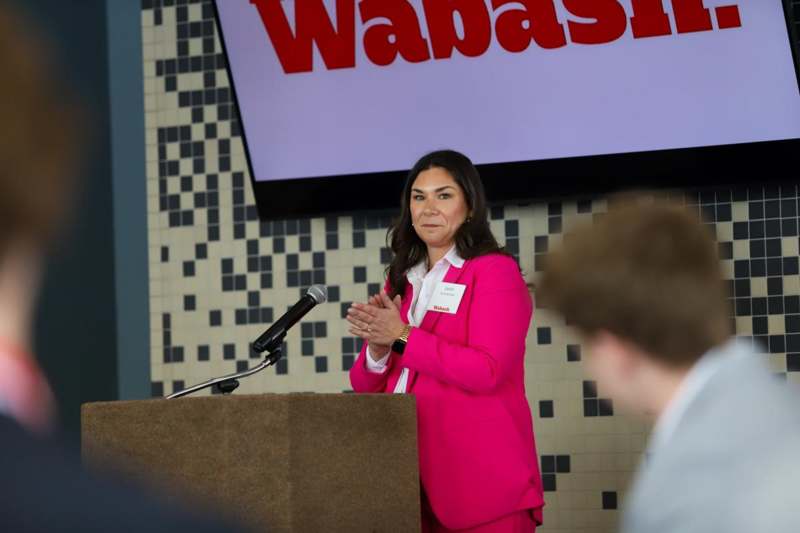 a woman standing at a podium with a microphone