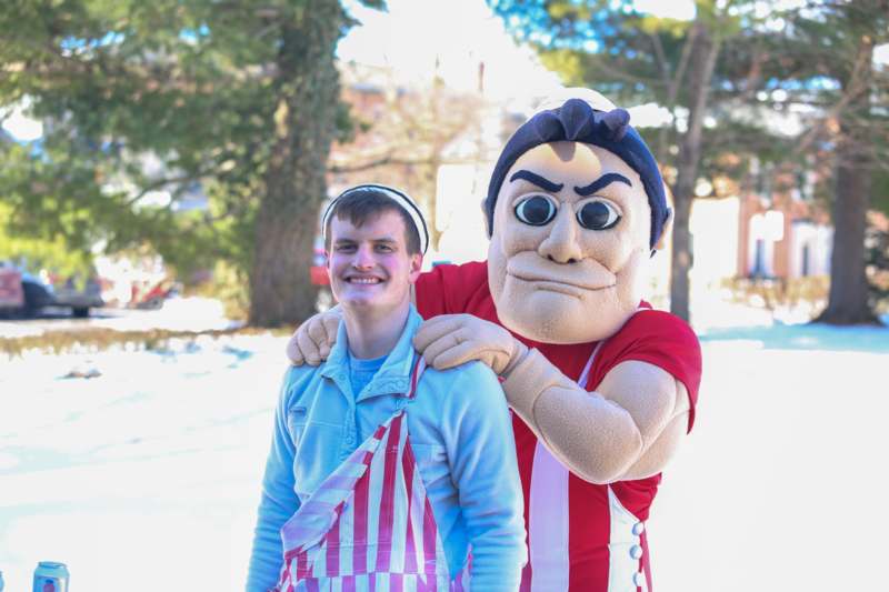 a man in a garment with a person in a apron