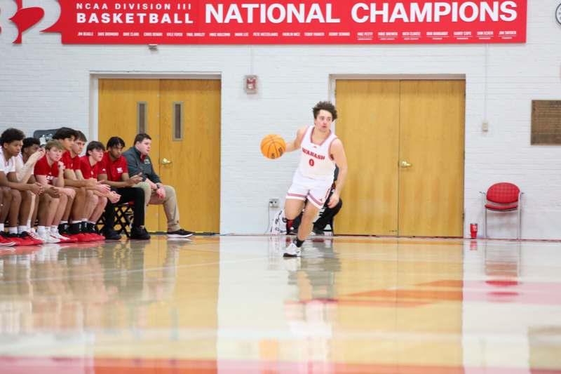 a man in a basketball uniform dribbling a basketball