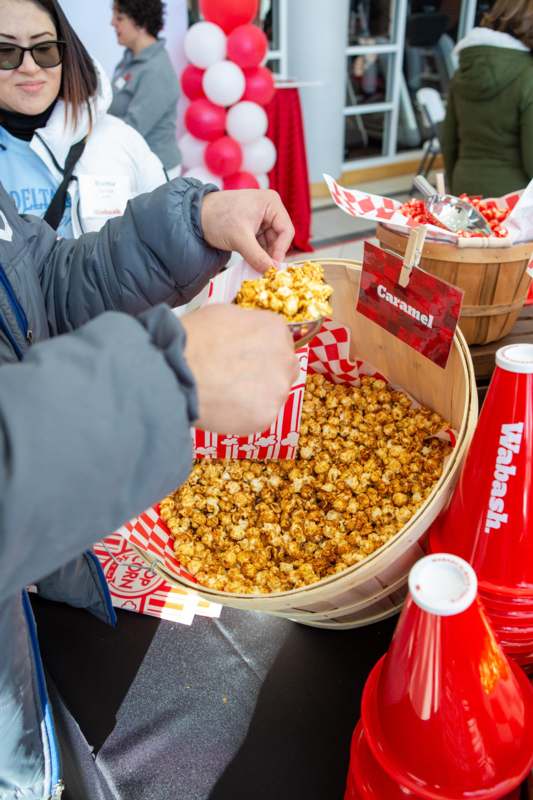 a person holding a bowl of popcorn