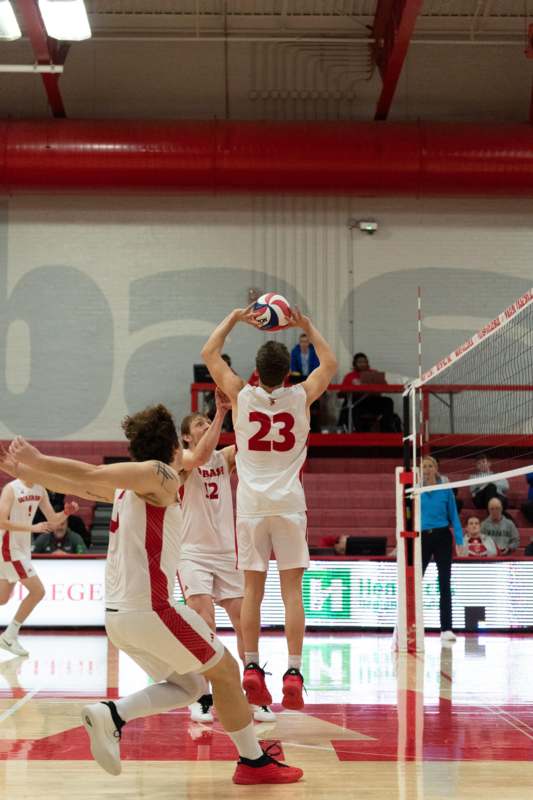 a group of people playing volleyball