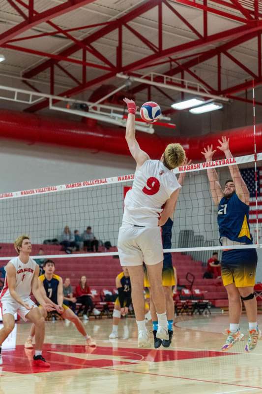 a group of people playing volleyball