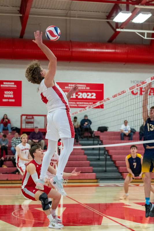 a group of people playing volleyball