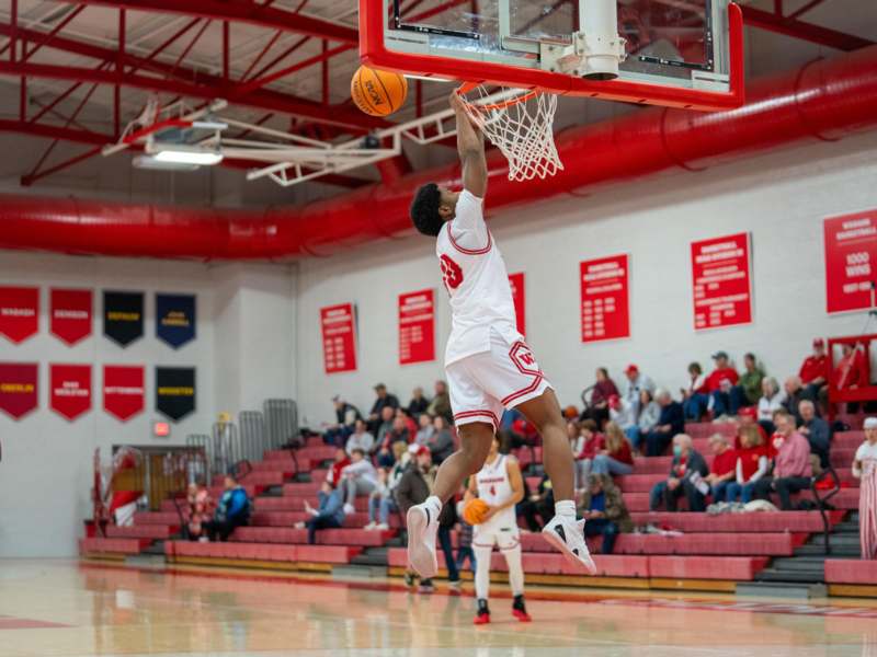 a man jumping in the air to dunk a basketball