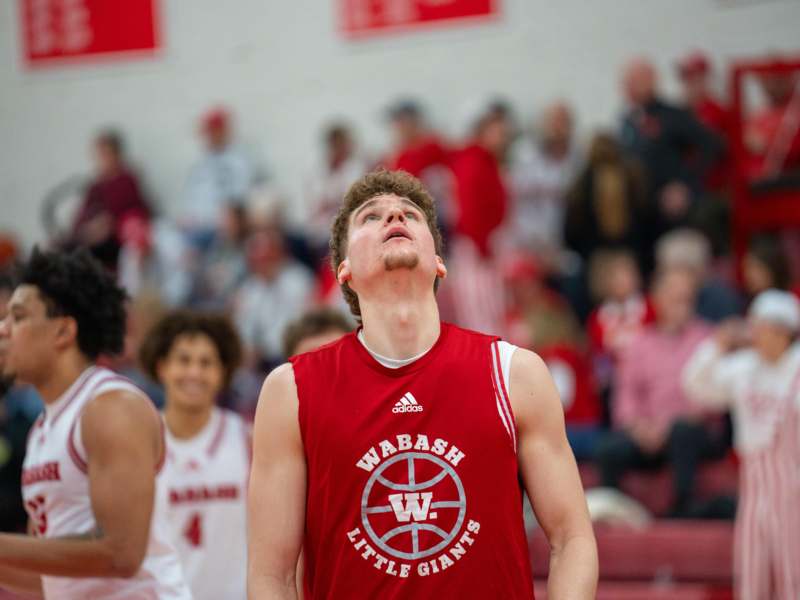 a man in a basketball jersey looking up