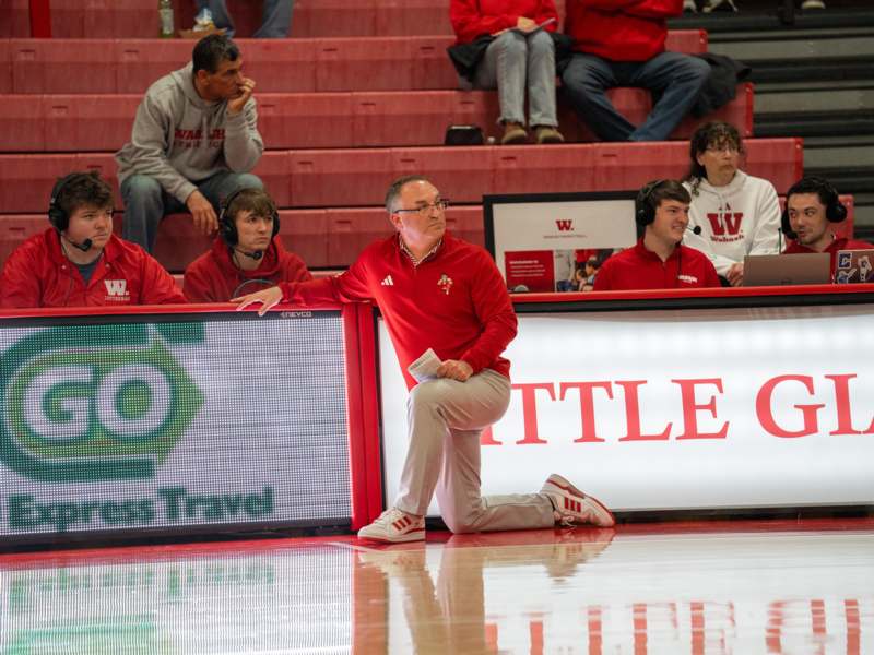 a man in red shirt sitting on the floor