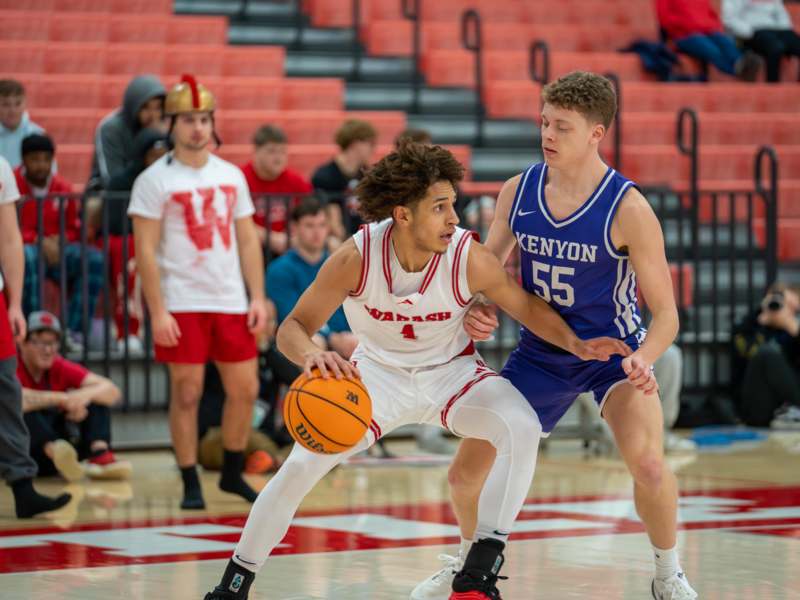 a basketball player in uniform dribbling a basketball
