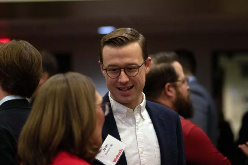 a man in a suit talking to a woman