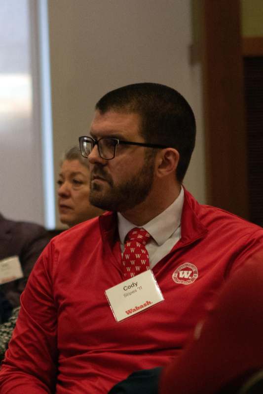 a man wearing a red shirt and tie