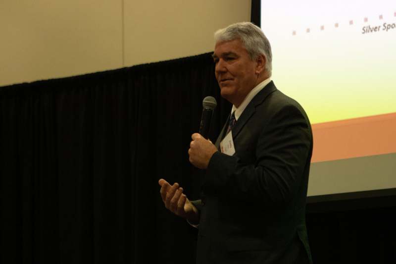 a man in a suit holding a microphone