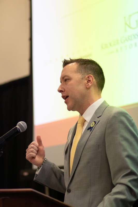 a man in a suit giving a thumbs up