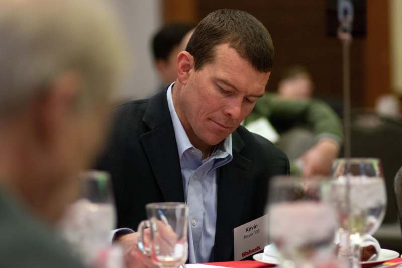 a man in a suit holding a pen