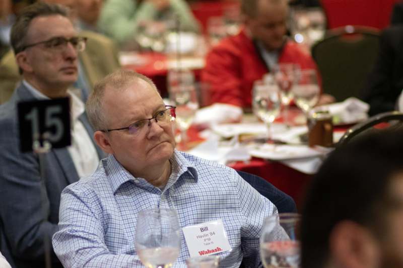 a man sitting at a table with glasses