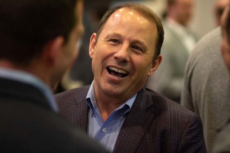 a man in a suit laughing