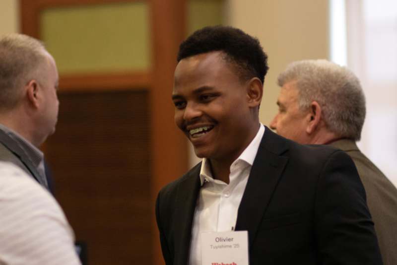 a man in a suit smiling