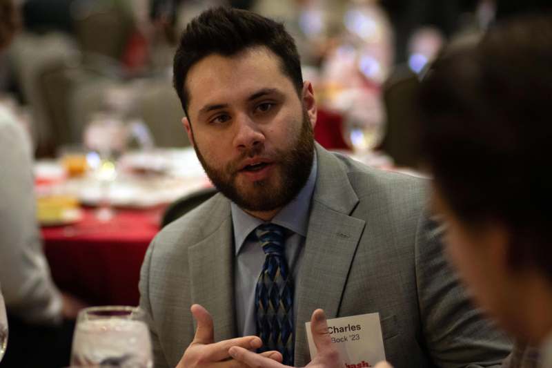a man in a suit talking to another man