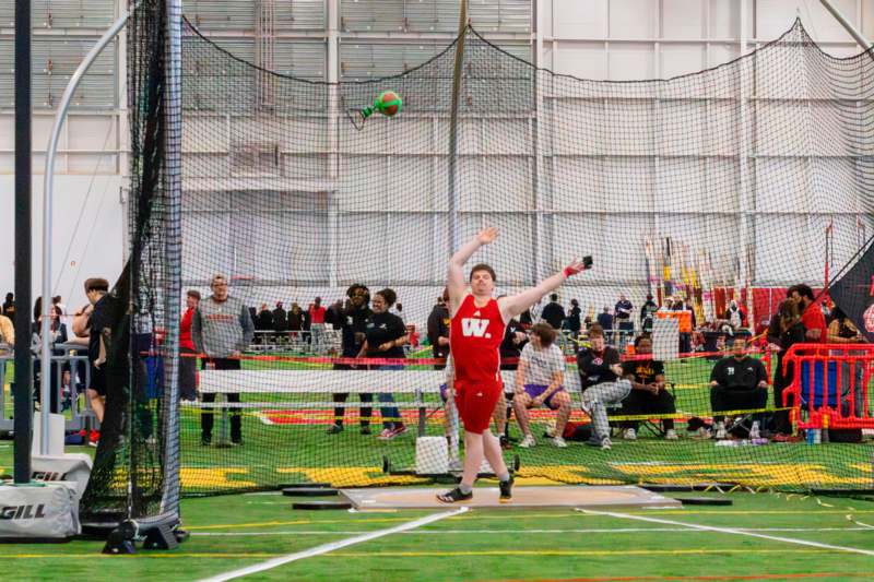 a man throwing a ball in a net