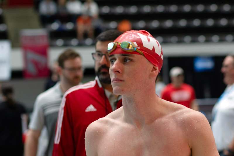 a man wearing a swim cap and goggles