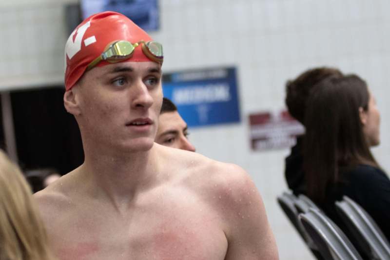 a man wearing a swim cap and goggles