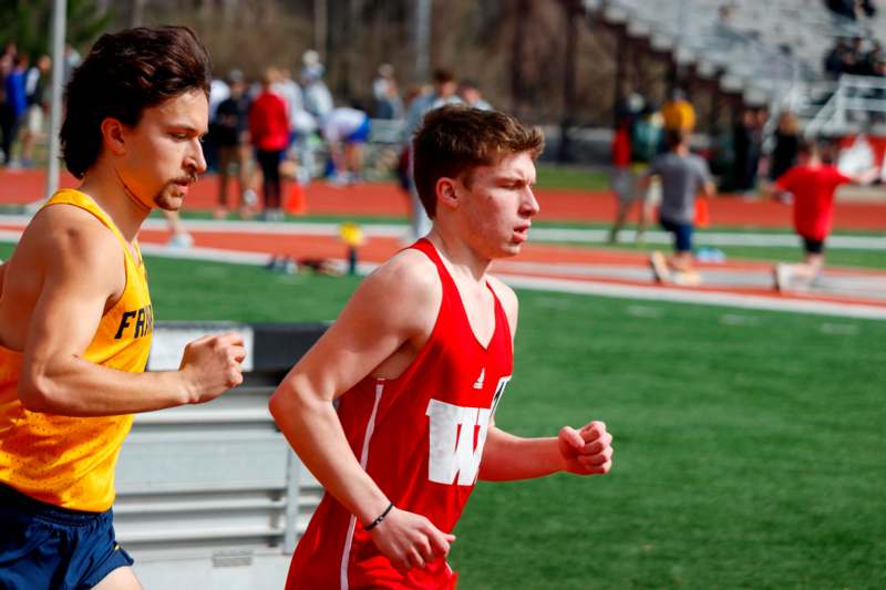 two men running on a track
