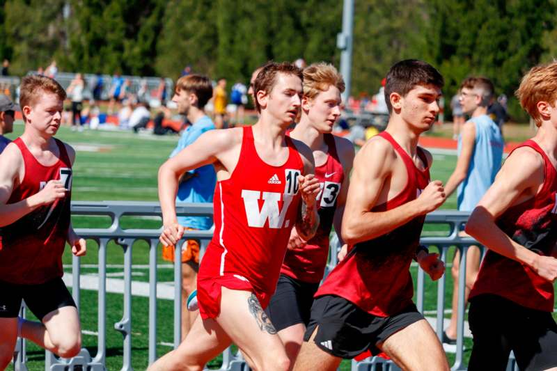a group of men running on a track