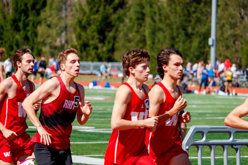 a group of men running on a track