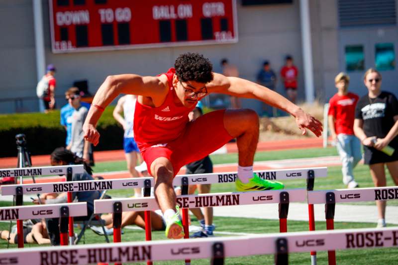 a man jumping over hurdles
