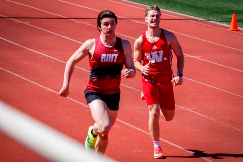 two men running on a track