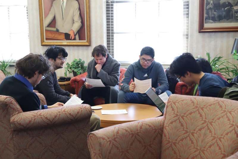 a group of people sitting around a round table