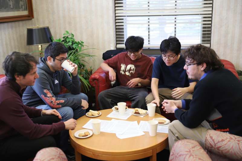 a group of people sitting around a round table