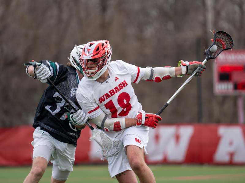 a group of people playing lacrosse