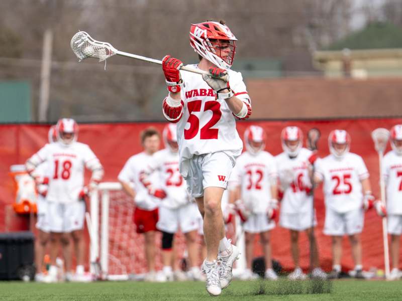 a man in a lacrosse uniform holding a stick