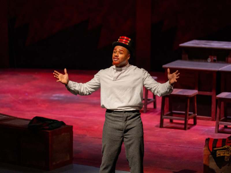 Lenin's Embalmers | Winter 2026 - a man wearing a hat and standing on a stage