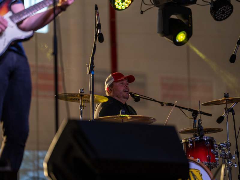 a man playing drums on a stage