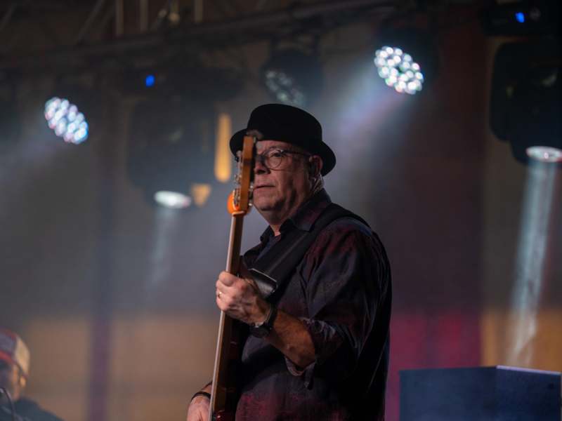 a man playing a guitar on stage