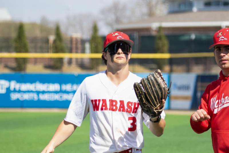 a man wearing a baseball uniform and a baseball glove