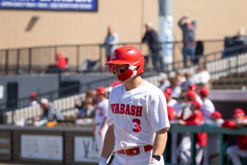 a baseball player in a red helmet