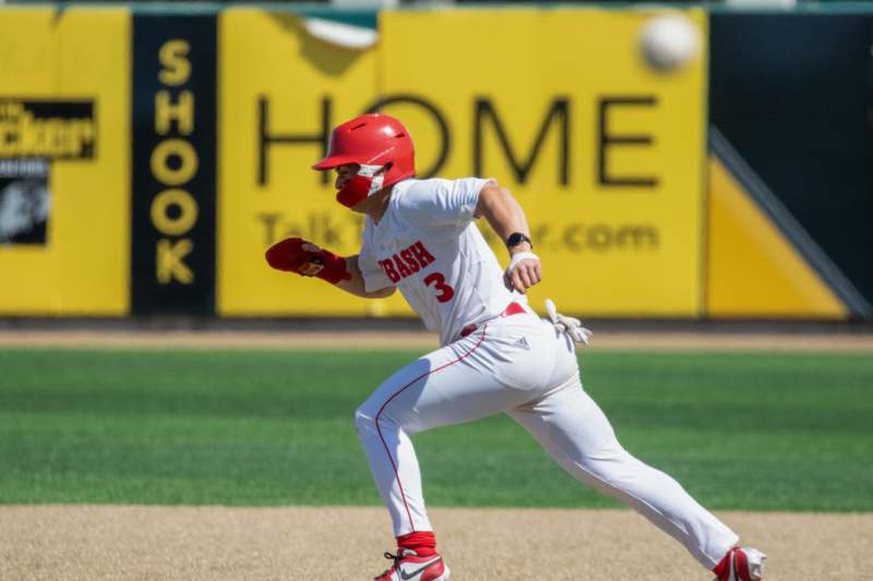 a baseball player running to first base