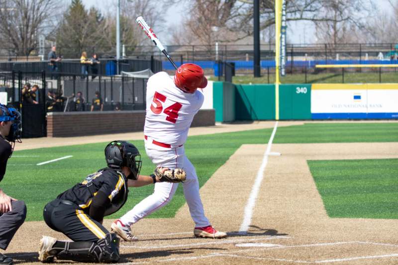 a baseball player swinging a bat