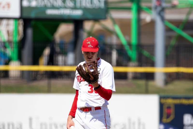 a baseball player holding a glove
