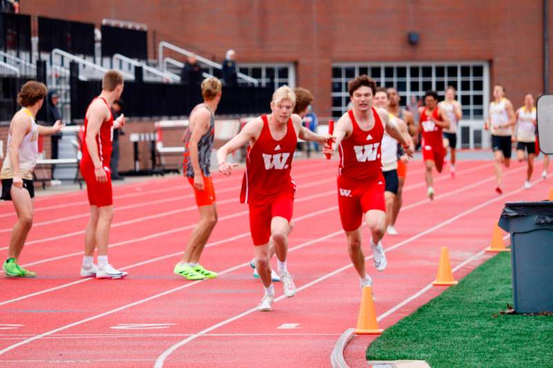a group of men running on a track
