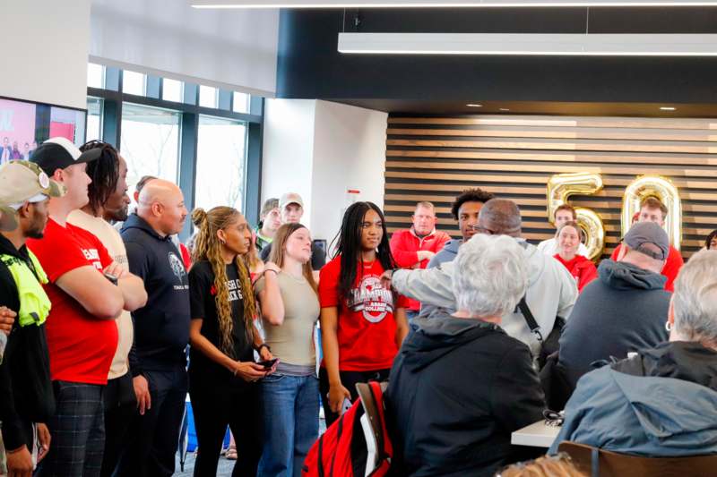 a group of people standing around a table