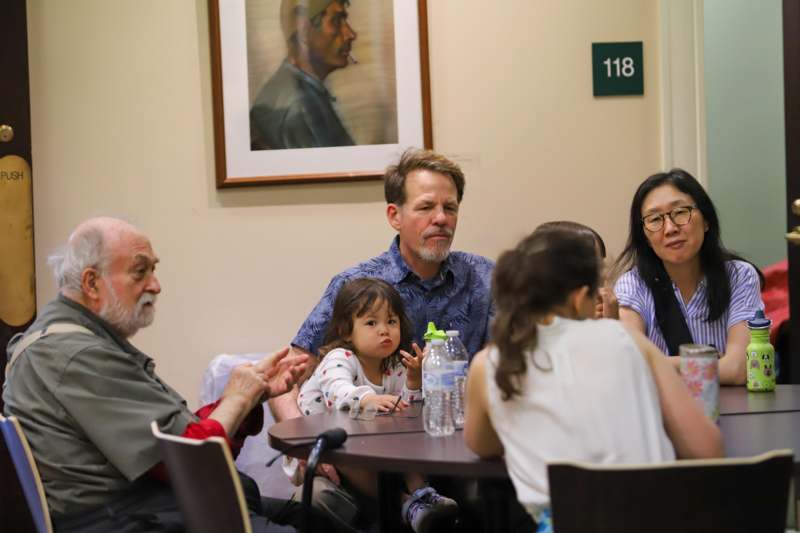 a group of people sitting around a table